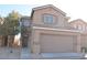 Inviting two-story home with a large front-facing two car garage and low maintenance desert landscaping at 4473 Oberlander Ave, North Las Vegas, NV 89031