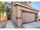 Two story house with a front entrance and a closed two car garage at 4473 Oberlander Ave, North Las Vegas, NV 89031