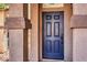 Dark blue front door with textured columns and a stone walkway at 4473 Oberlander Ave, North Las Vegas, NV 89031