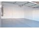 Clean, empty garage space featuring a sealed concrete floor and freshly painted white walls at 4473 Oberlander Ave, North Las Vegas, NV 89031