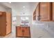 Bright kitchen features wood cabinets, marble counters and backsplash, and stainless steel faucet at 4473 Oberlander Ave, North Las Vegas, NV 89031