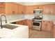 Stainless steel appliances, bright countertops, and wood cabinets in this remodeled kitchen at 4473 Oberlander Ave, North Las Vegas, NV 89031