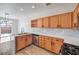 Well-lit kitchen with stainless steel appliances, wooden cabinets, and marble countertops and island at 4473 Oberlander Ave, North Las Vegas, NV 89031