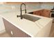 A large kitchen island has a stainless steel sink and a white countertop at 4473 Oberlander Ave, North Las Vegas, NV 89031