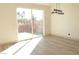 This living room features sliding glass doors to the back with light wood-look flooring at 4473 Oberlander Ave, North Las Vegas, NV 89031