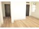 View of the room's door, light wood-look flooring, and white walls at 4473 Oberlander Ave, North Las Vegas, NV 89031