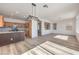 Inviting living room with wood-look flooring, open to the kitchen with an island bar, and plenty of natural light at 4473 Oberlander Ave, North Las Vegas, NV 89031