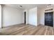 Open living space with wood-look flooring, a dark front door, and stairway access, creating a welcoming and functional design at 4473 Oberlander Ave, North Las Vegas, NV 89031