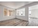 Bright living room featuring wood-look flooring, multiple windows, and an open layout perfect for entertaining guests at 4473 Oberlander Ave, North Las Vegas, NV 89031