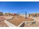 Community playground featuring swings, slides, and a wood chip ground cover at 4473 Oberlander Ave, North Las Vegas, NV 89031