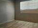 An empty bedroom with wood-look flooring and a large window at 4504 Cinderella Ln, Las Vegas, NV 89102