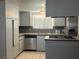 Functional kitchen area with ample cabinet space, stainless steel appliances, and tile flooring at 4504 Cinderella Ln, Las Vegas, NV 89102