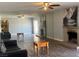 Inviting living room featuring a decorative fireplace, laminate flooring, and ample natural light at 4504 Cinderella Ln, Las Vegas, NV 89102