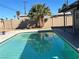 Residential pool with trees and blue water at 4504 Cinderella Ln, Las Vegas, NV 89102