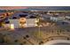 Panoramic aerial view of the home featuring solar panels, an illuminated patio, and a beautifully landscaped backyard at 4504 Eagle Nest Peak St, Las Vegas, NV 89129