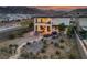 Aerial view of a private backyard featuring desert landscaping, a cozy patio, and mountain views at 4504 Eagle Nest Peak St, Las Vegas, NV 89129