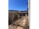 View of a fenced backyard with desert landscaping and an open gate leading to a greenbelt behind the house at 4504 Eagle Nest Peak St, Las Vegas, NV 89129