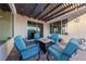 Covered patio with table and chairs, string lights, brick flooring and view of the desert landscape at 4504 Eagle Nest Peak St, Las Vegas, NV 89129