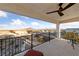 Spacious covered balcony with mountain views, outdoor ceiling fan, and stylish wrought iron at 4504 Eagle Nest Peak St, Las Vegas, NV 89129