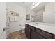 Bathroom features a single sink vanity with dark wood cabinets, white countertops, framed art and shower-tub combo at 4504 Eagle Nest Peak St, Las Vegas, NV 89129