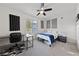 Bright bedroom featuring carpet, ceiling fan, a study desk, a full sized bed, and a bedside table at 4504 Eagle Nest Peak St, Las Vegas, NV 89129