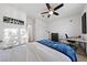 Bedroom featuring a white and blue bed, ceiling fan, desk, and Beatles decoration at 4504 Eagle Nest Peak St, Las Vegas, NV 89129