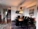 Formal dining room with a dark wood table, black leather chairs, and modern decor at 4504 Eagle Nest Peak St, Las Vegas, NV 89129