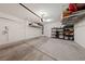 A clean and organized garage featuring ample storage space with shelving units and overhead racks at 4504 Eagle Nest Peak St, Las Vegas, NV 89129