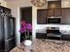 Kitchen featuring stainless steel appliances, granite countertops, and a stylish orchid centerpiece at 4504 Eagle Nest Peak St, Las Vegas, NV 89129