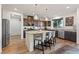 Open kitchen featuring granite countertops, stainless steel appliances, and a kitchen island with barstool seating at 4504 Eagle Nest Peak St, Las Vegas, NV 89129