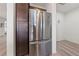 Stainless steel refrigerator with pantry and wood-look laminate flooring at 4504 Eagle Nest Peak St, Las Vegas, NV 89129