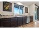 Kitchen features modern appliances, undermount sink with granite countertops, and wood-look laminate flooring at 4504 Eagle Nest Peak St, Las Vegas, NV 89129