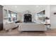 Bright living room features a ceiling fan, white couches, and large windows at 4504 Eagle Nest Peak St, Las Vegas, NV 89129