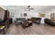 Spacious living room featuring wood floors, ceiling fan, and comfortable seating perfect for Gathering relaxation at 4504 Eagle Nest Peak St, Las Vegas, NV 89129