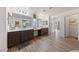 The main bathroom has double sinks, dark cabinetry and hardwood flooring at 4504 Eagle Nest Peak St, Las Vegas, NV 89129