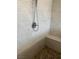 A close-up of a shower shows the gray tile and the pebble floor at 4504 Eagle Nest Peak St, Las Vegas, NV 89129