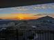 Sunrise view from a high-elevation balcony overlooking rooftops to distant hills at 4504 Eagle Nest Peak St, Las Vegas, NV 89129