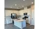 Bright kitchen featuring white cabinetry, stainless steel appliances, and a central island with seating at 4540 Anspach St, North Las Vegas, NV 89031