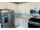 Kitchen showcasing white cabinets, stainless steel appliances, and granite countertops at 4540 Anspach St, North Las Vegas, NV 89031