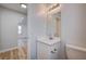 Clean bathroom with white vanity, mirror, and a view to the hall at 4839 Englewood Ave, Las Vegas, NV 89139