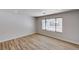 Bright bedroom with modern wood floors and large window overlooking backyard patio space at 4839 Englewood Ave, Las Vegas, NV 89139