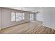 Bright and airy living room showcasing wood floors, large windows, and sliding glass doors overlooking outdoor patio at 4839 Englewood Ave, Las Vegas, NV 89139