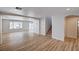 Large living room with light wood floors and neutral walls, featuring a staircase and abundant natural light at 4839 Englewood Ave, Las Vegas, NV 89139