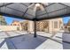 View of house from under the gazebo, showing patio and landscaping at 4925 Turtle Point Dr, Las Vegas, NV 89113