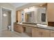 A spacious bathroom featuring double sinks, vanity, and a door leading to a separate room at 4925 Turtle Point Dr, Las Vegas, NV 89113