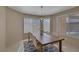 Dining room showcasing a large table, modern chandelier, and natural light through the windows at 4925 Turtle Point Dr, Las Vegas, NV 89113