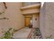 Home entryway with a custom front door and desert landscaping at 4925 Turtle Point Dr, Las Vegas, NV 89113