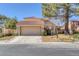 Charming home featuring a tile roof, two car garage and desert landscaping at 4925 Turtle Point Dr, Las Vegas, NV 89113