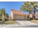 Beautiful home featuring a tile roof, desert landscaping and an attached garage at 4925 Turtle Point Dr, Las Vegas, NV 89113