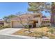 Inviting home showcasing desert landscaping, a tile roof, and a two-car garage at 4925 Turtle Point Dr, Las Vegas, NV 89113